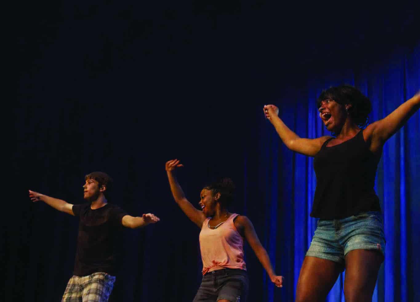 Students performing on stage during a cultural event.